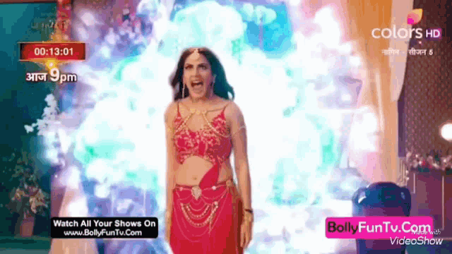 a woman in a red crop top is screaming in front of a screen that says colors hd