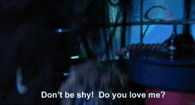 a man in a blue jacket and tie says " do you love me ? "