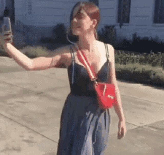 a woman is taking a picture of herself with a cell phone