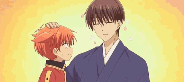 a man and a boy are standing next to each other and the boy has a cat ear .