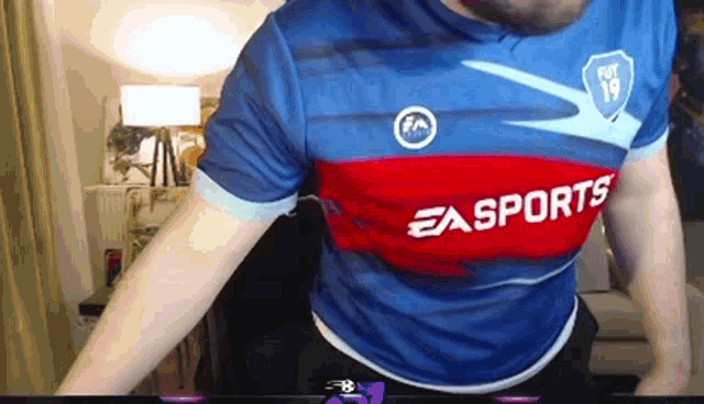 a man is wearing a blue and red ea sports jersey