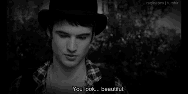 a black and white photo of a man with the words " you look beautiful "