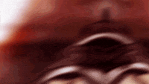 a close up of a person 's face with a blurred background .