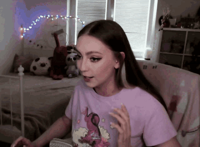 a woman wearing a purple shirt with a picture of a sheep on it
