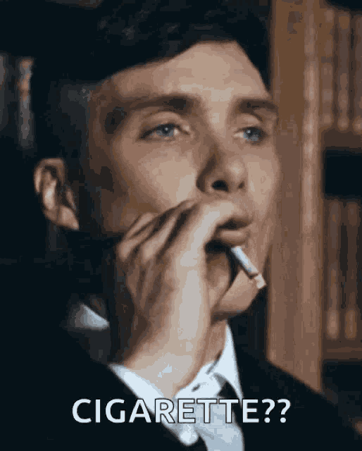 a man in a suit is smoking a cigarette and saying cigarette ?