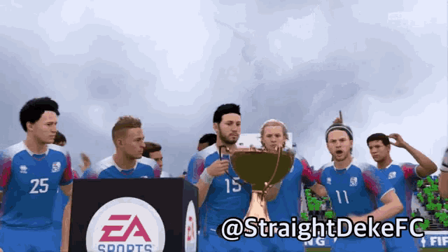 a group of soccer players are holding a trophy in front of a ea sports sign