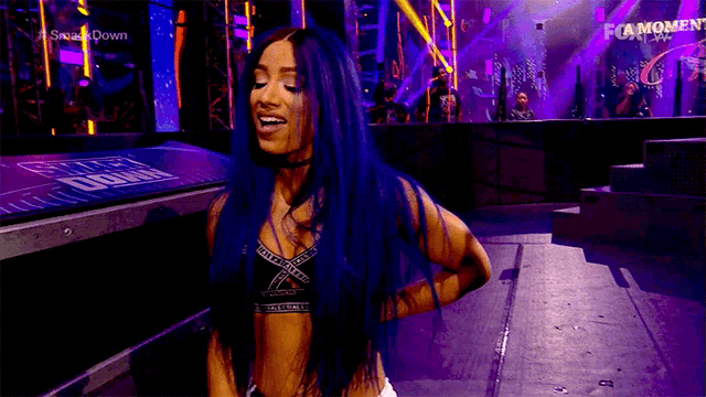 a woman with blue hair is standing on a stage in front of a fox logo .