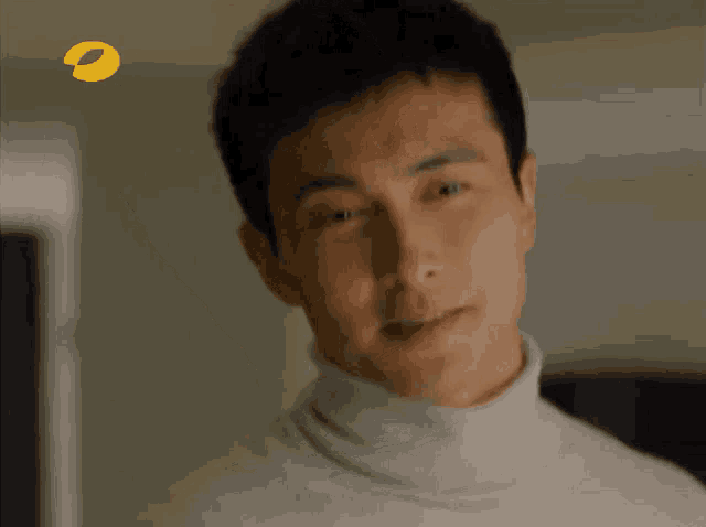 a close up of a man 's face with a yellow circle in the corner