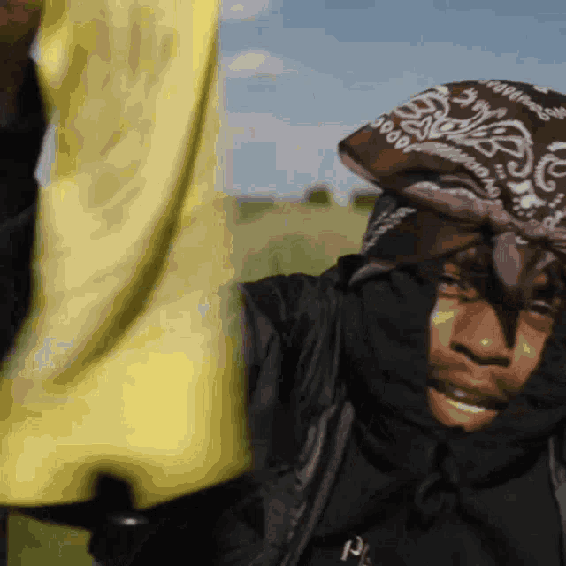 a person wearing a bandana that says ' hood ' on it