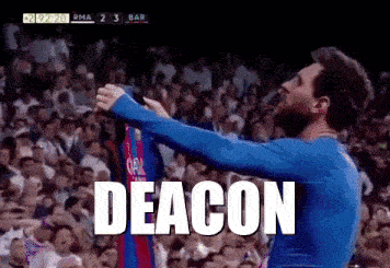 a man in a blue shirt is holding up a jersey with the word deacon on it