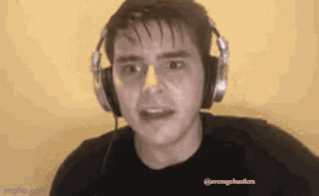 a man wearing headphones is making a funny face