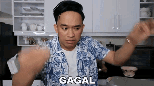 a man in a blue and white shirt with the word gagal written on his chest
