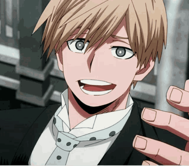 a close up of a person wearing a tuxedo and tie smiling