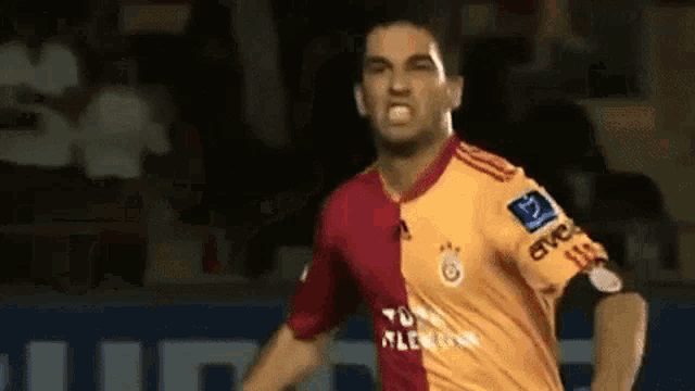 a soccer player wearing a red and orange jersey with the word evo on it