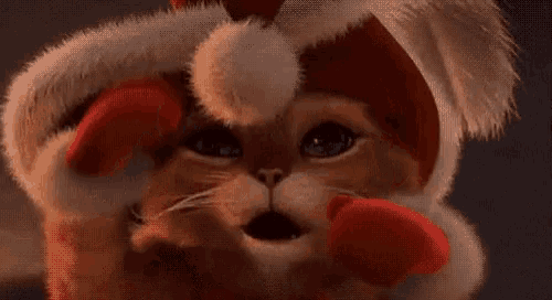 a close up of a cartoon cat wearing a hat and a red nose .