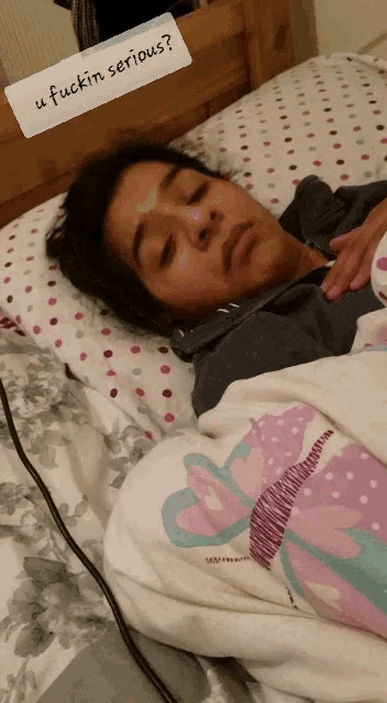 a person laying in bed with a sticker that says " u fuckin serious "