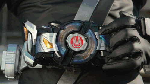 a person is wearing a belt with a red circle with the letter m on it