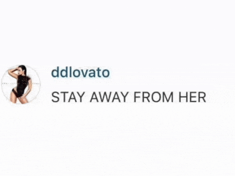 a picture of a woman in a black bodysuit with the words `` stay away from her '' written below it .
