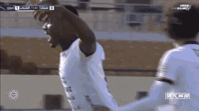 a soccer game is being played in a stadium and the score is 0-1