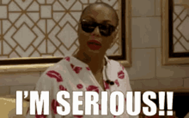 a woman wearing sunglasses and a robe says i 'm serious