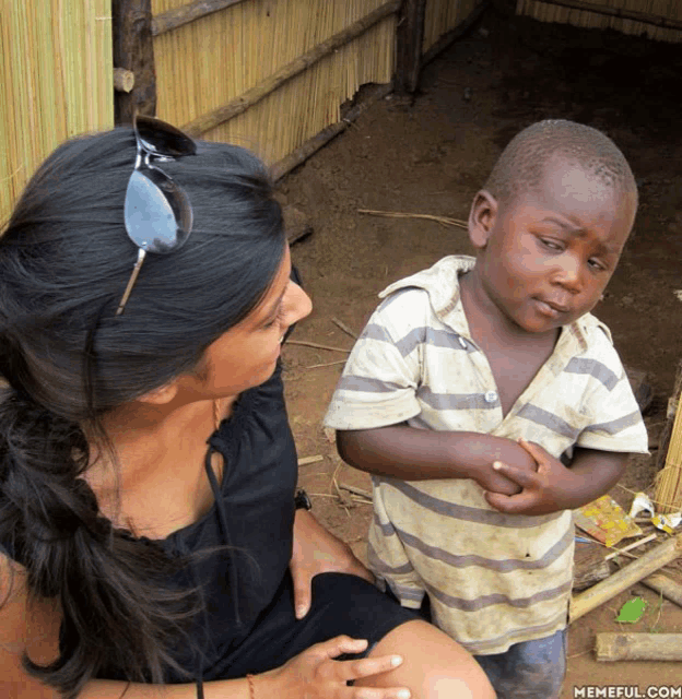 a woman sitting next to a young boy with a memeful.com watermark on the bottom