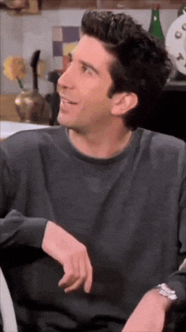 a close up of a man wearing a gray shirt