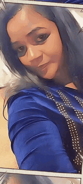 a woman wearing a blue shirt with polka dots on it
