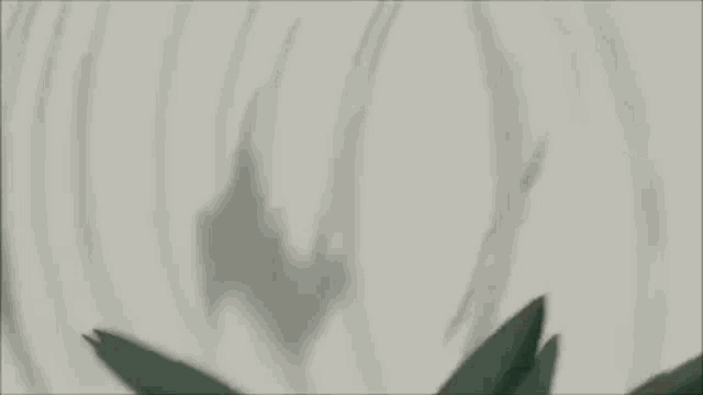 a white object is flying through the air in a dark room .