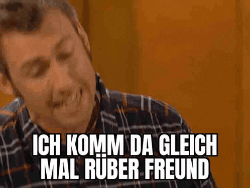 a man in a plaid shirt is making a funny face and saying ich komm da glech mal ruber freund .