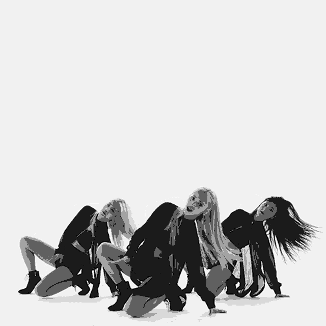 a black and white photo of a group of girls dancing