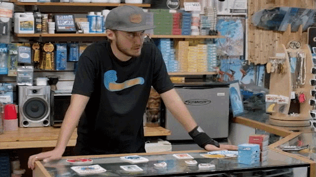 a man wearing a nike shirt stands in front of a counter