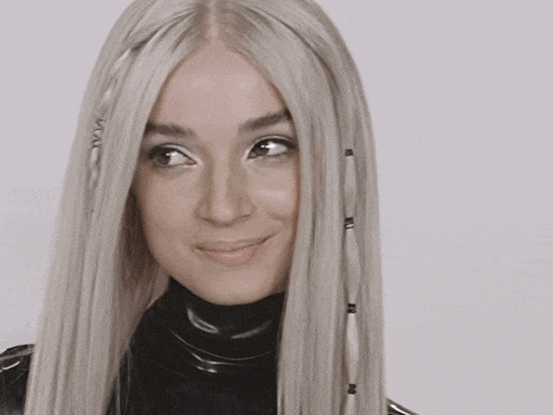 a close up of a woman 's face with a wig on
