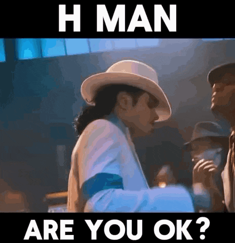 a man in a white suit and hat is standing in front of a sign that says h man are you ok