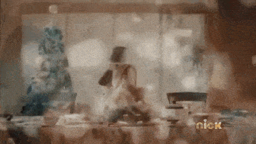 a blurred image of a woman standing in front of a window with the word nick on the bottom