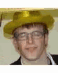a young man wearing a yellow hat and glasses .