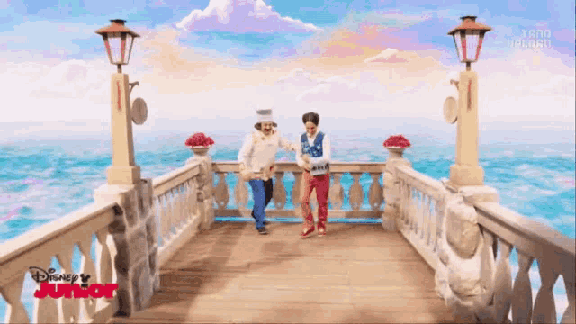 two cartoon characters dancing on a pier with disney junior written on the bottom
