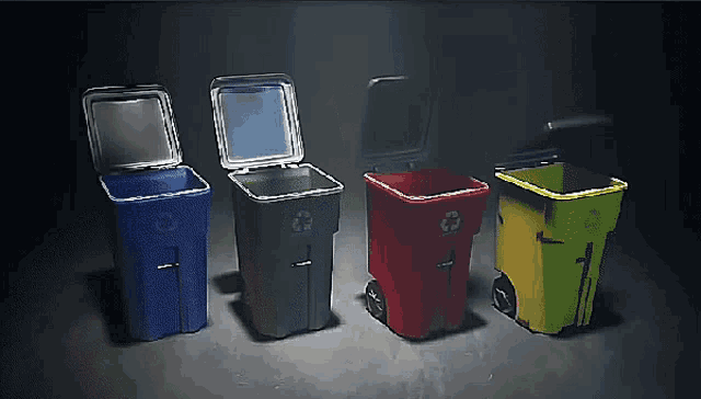 four garbage cans of different colors are lined up in a row with one of them open