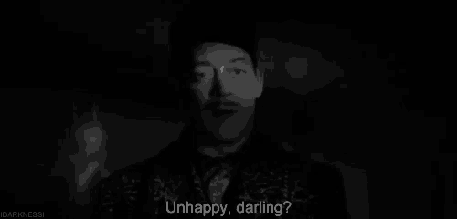 a black and white photo of a man with a mustache and the words `` unhappy , darling '' .