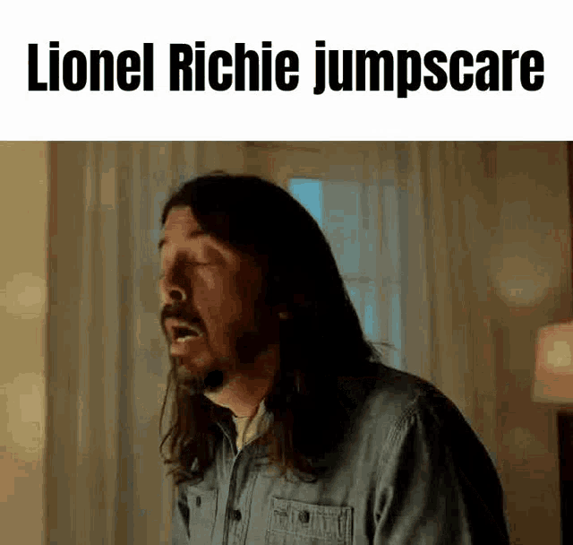 a man with long hair and a beard is making a funny face with his mouth open .