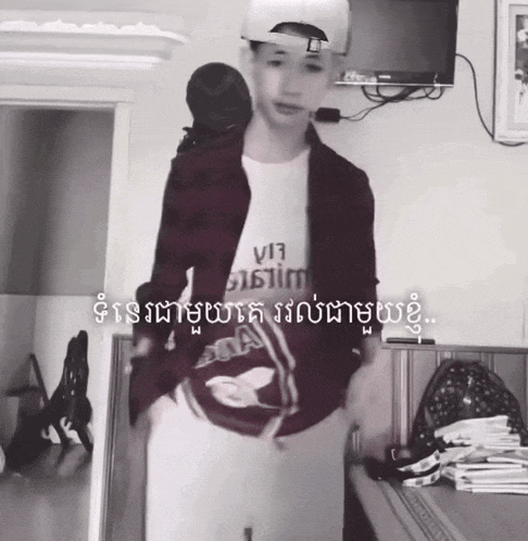 a black and white photo of a person wearing a t-shirt that says v17