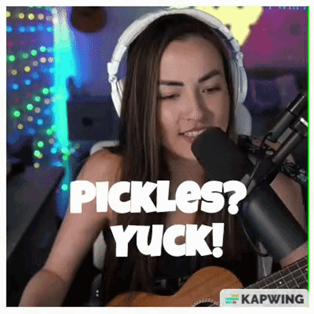 a woman singing into a microphone with the words pickles yuck