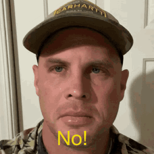 a man wearing a carhartt hat says no in yellow