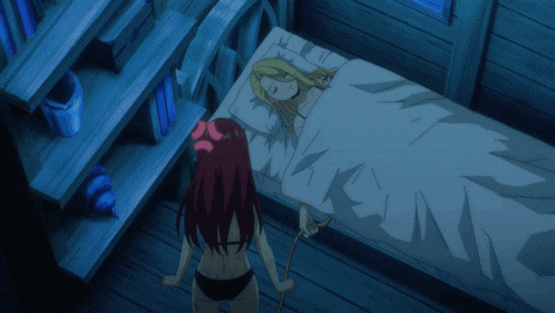 a girl with red hair is standing next to a bed