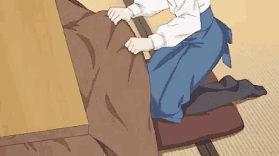 a cartoon of a person kneeling down holding a brown blanket