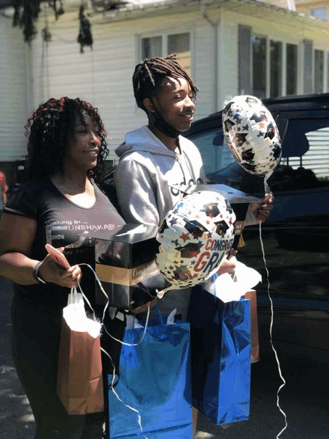 a man and a woman holding balloons that say comeback girl