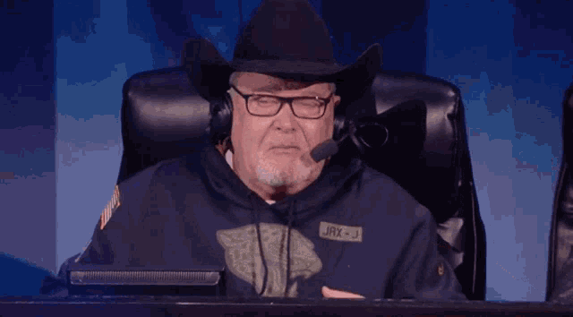 an older man wearing a cowboy hat and headphones has a name tag that says jrx-j