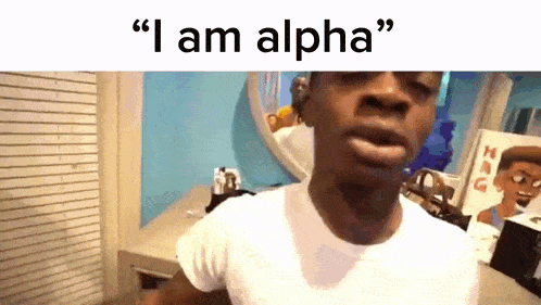 a man in a white shirt says " i am alpha " while standing in front of a mirror