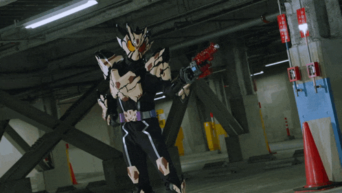 a man in a black costume is holding a gun