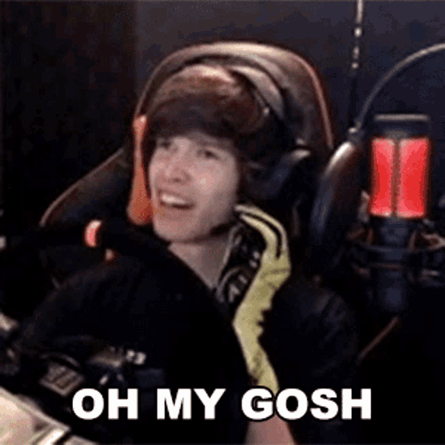 a man wearing headphones and a microphone is sitting in front of a microphone with the words `` oh my gosh '' .