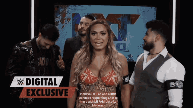 a woman in a wonder woman costume stands in front of a sign that says digital exclusive
